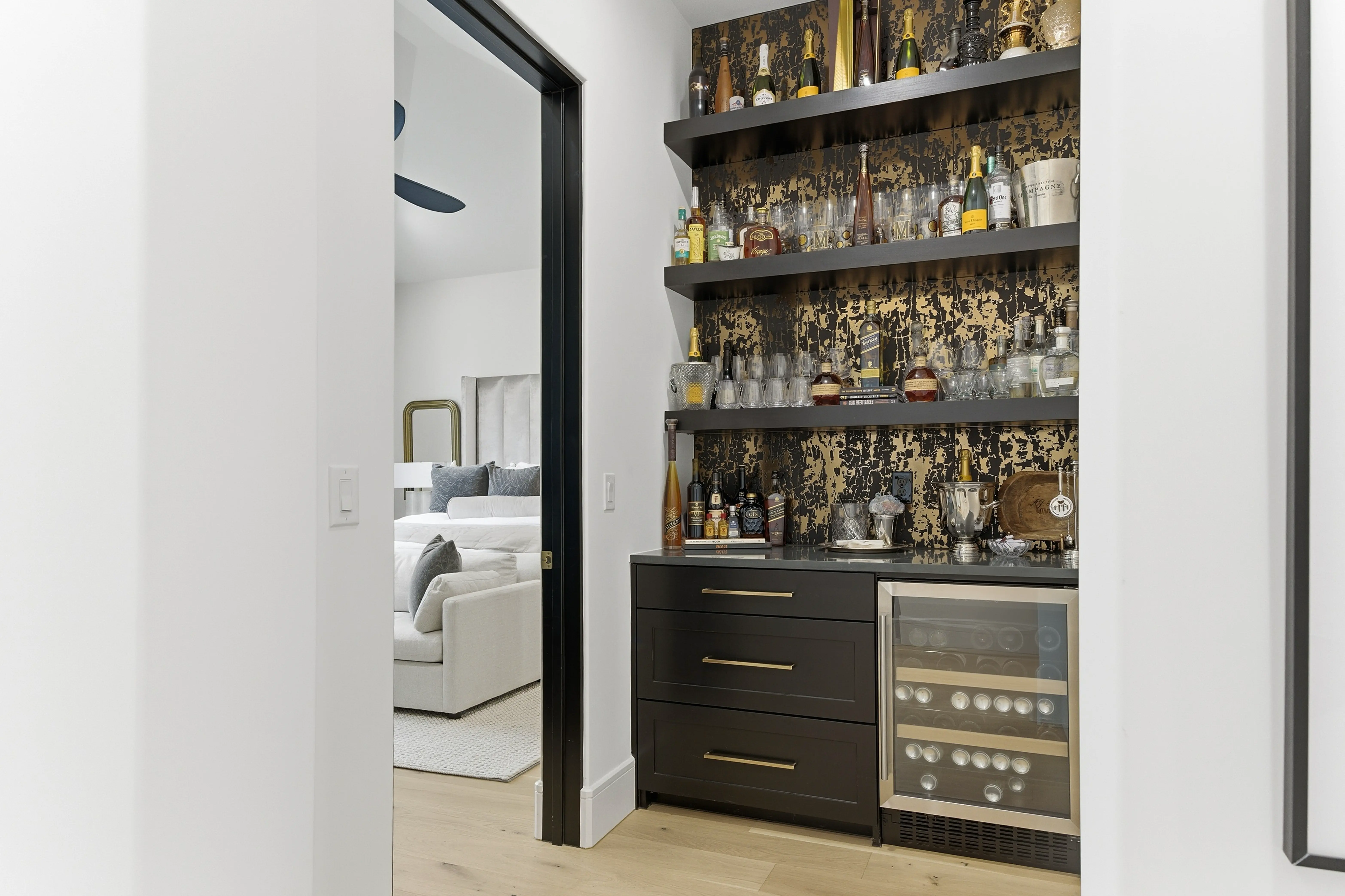 Built-in wet bar with wine fridge and designer wallpaper