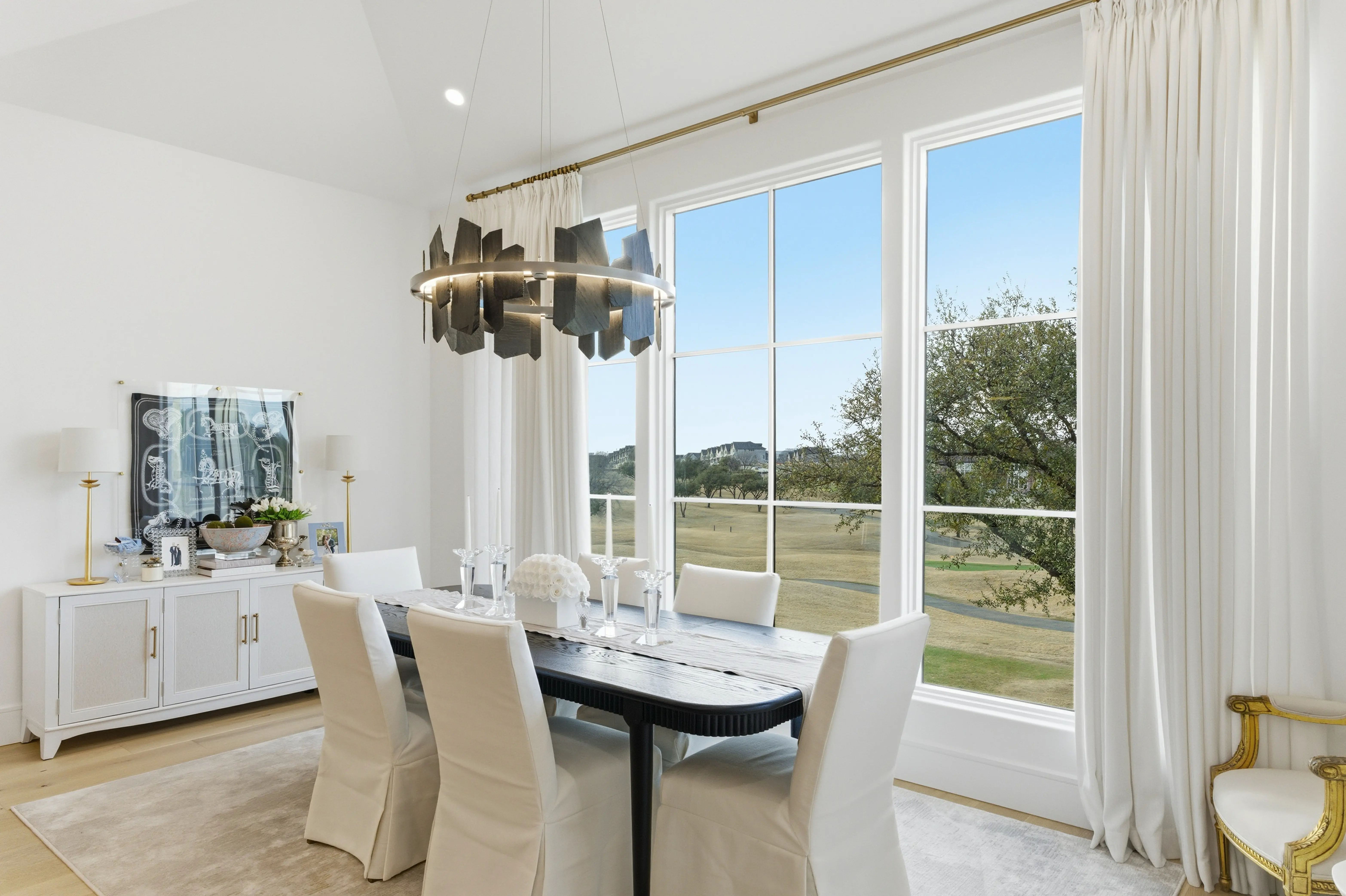 Dining area with golf course views through oversized windows